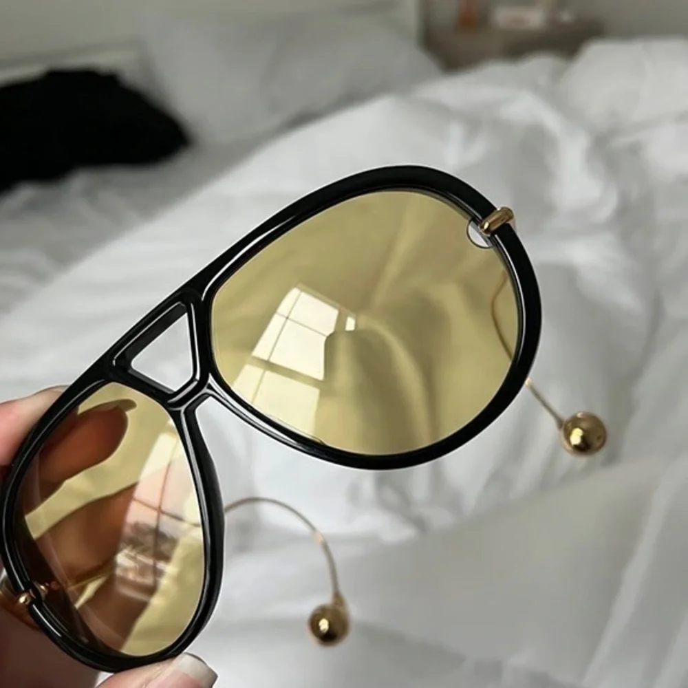 Bottega Veneta Black Frame Sunglasses with Yellow Lenses